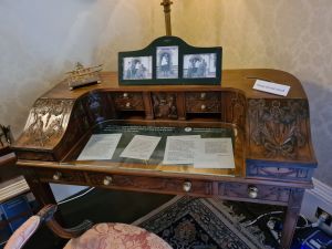 Wooden writing desk withold photos and letters